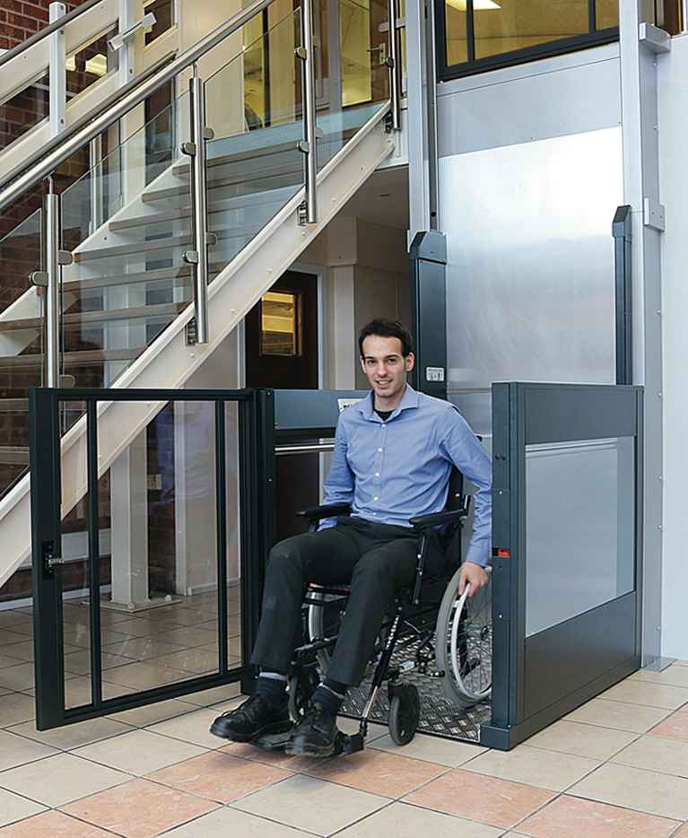 Young Man On Vertical Wheelchair Platform Lift